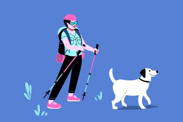 non binary hiker with a dog on a walk in nature. Hiking outdoors with walking sticks accompanied by pet Labrador.