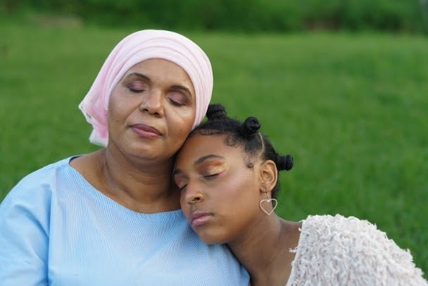 Family Portrait of Mother and Daughter in Garden, multigenerational diverse family, mother and daughter closed eyes leaning on each other