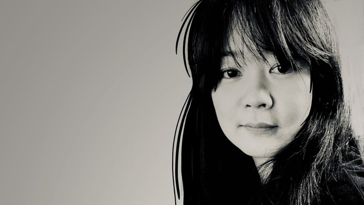 Photograph of Mizuho Call in black and white. Medium closeup, headshot portrait. Solid white, creamy color background. Long black hair. A digital pen drawing of black hair.