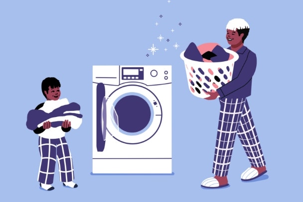 dad doing laundry with child. father fills washing machine with dirty cloths. man with launder basket doing household tasks. cleaning and chores.