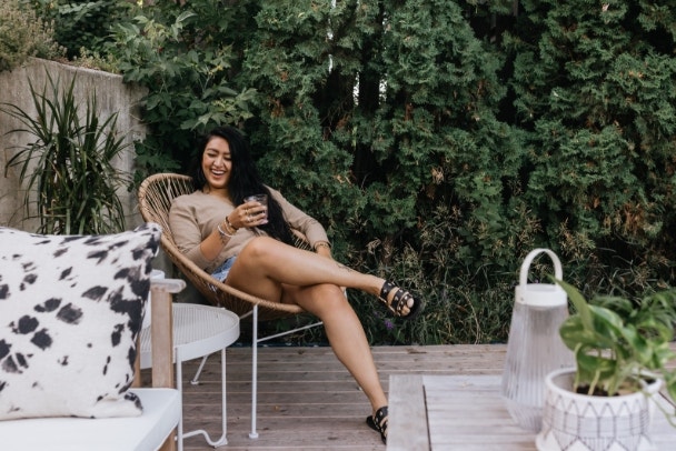 Young adult Filipino woman relaxing outdoors at home