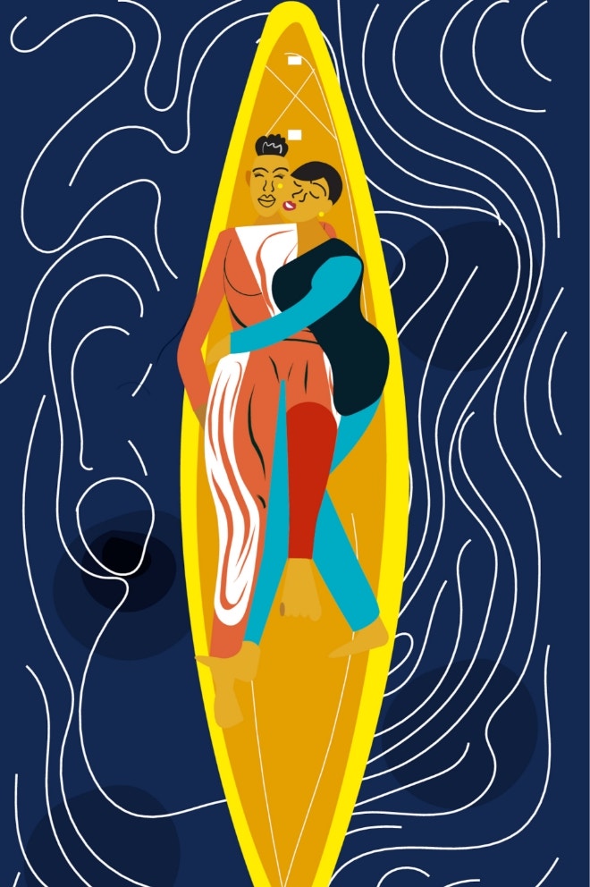 Lesbian couple laying on a paddleboard