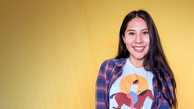 Lynne Hardy, member of the Navajo Nation, wearing a t-shirt she designed depicting her Grandmother riding a horse.