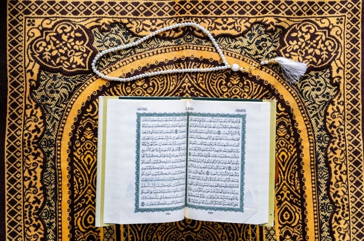 Black Muslim Woman studying quran