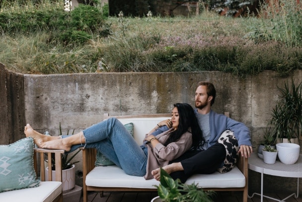 Interracial couple cuddling outside in summer