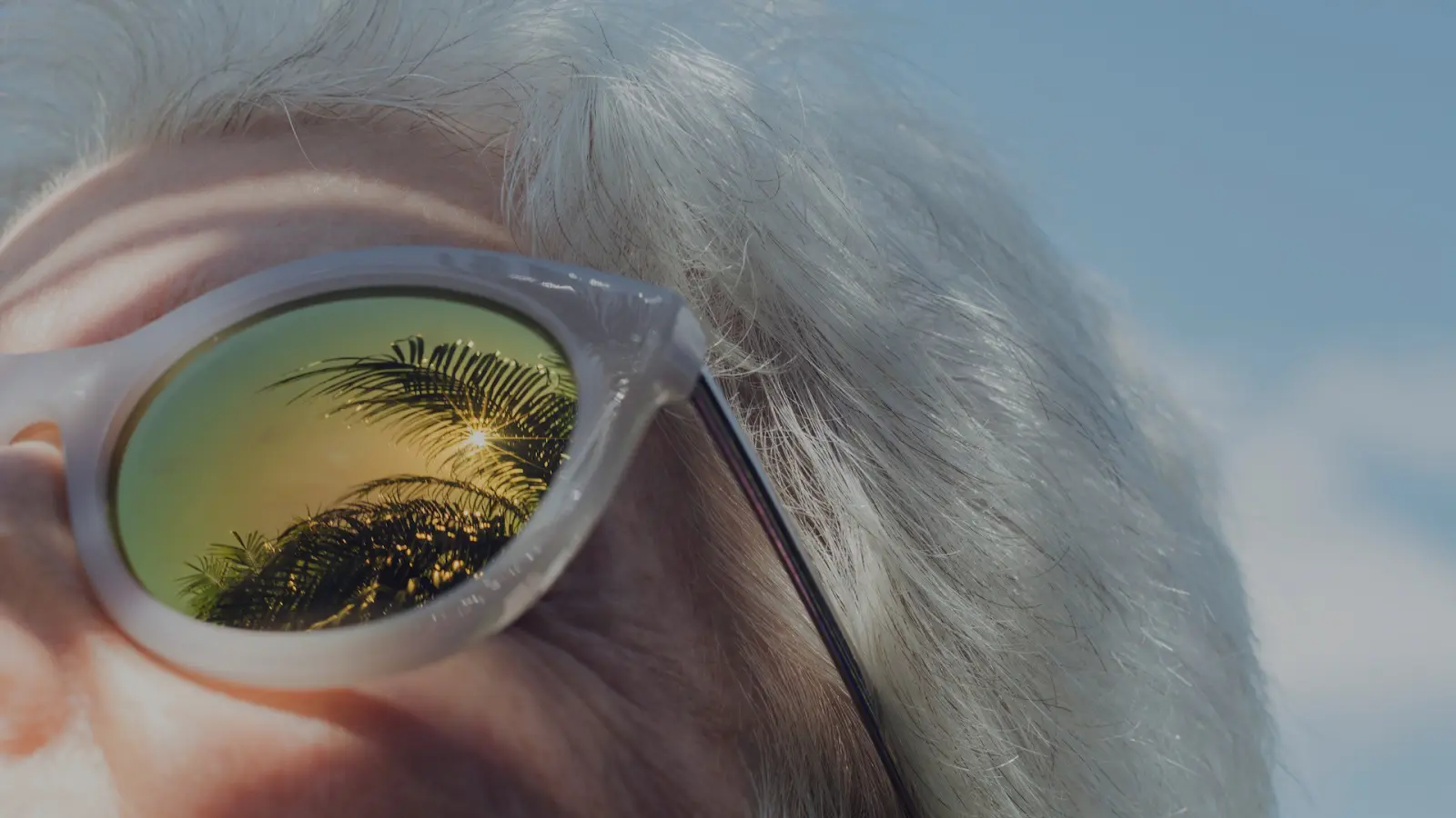 cool abstract photo of old woman wearing contemporary, reflective glasses, age positivity