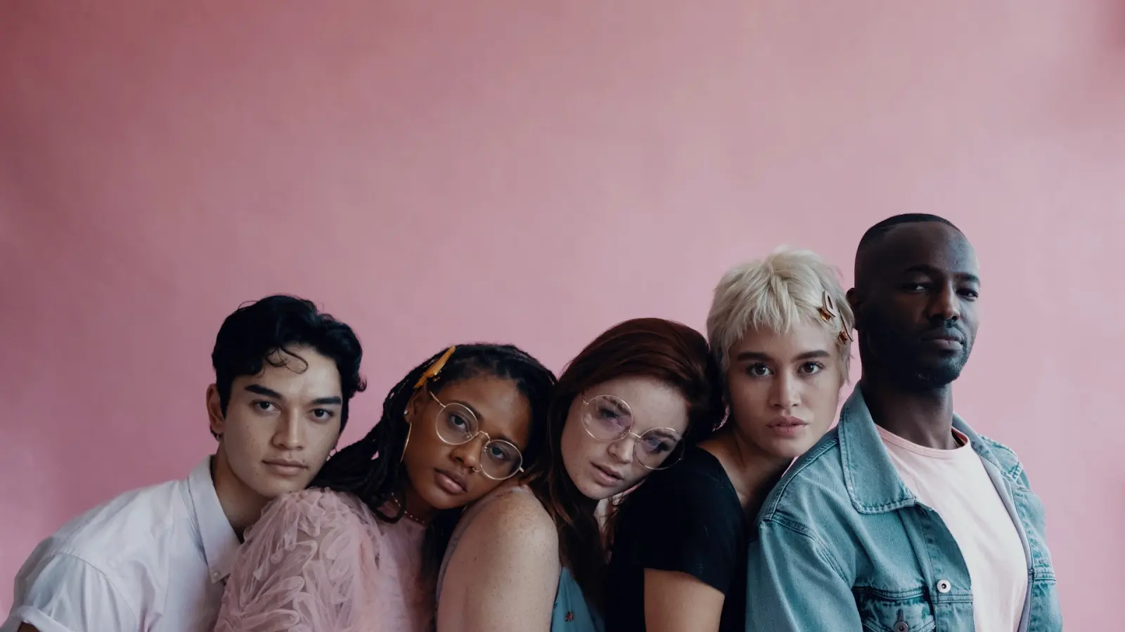 Group of diverse youth, cool black young man, Latinx friends, pink background, contemporary portrait of diverse group of friends