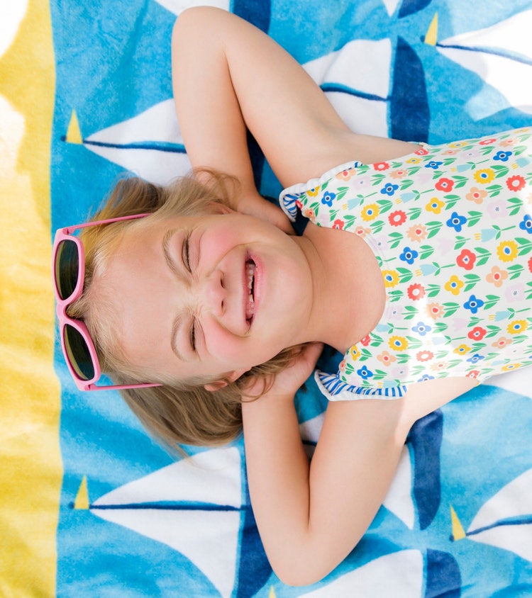 Little girl with down syndrome relaxing at the beach