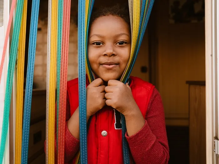 Black girl smiling while making fun with taps in trailer