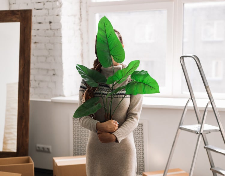 Woman relocating with a plant