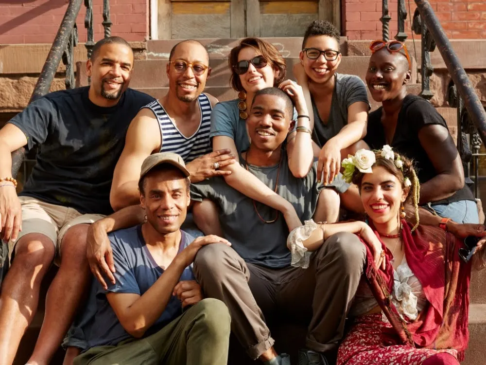 Friends smiling on front stoop By Granger Wootz/Blend Images